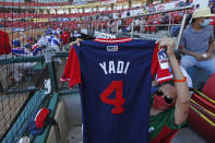 A fan holds up her Puerto Rican national team jersey autographed by Yadier "Yadi" Molina at a Caribbean Series baseball game against Panama in the Teodoro Mariscal stadium, in Mazatlan, Mexico, Thursday, Feb. 4, 2021. Puerto Rico won 9-8. (AP Photo/Moises Castillo)