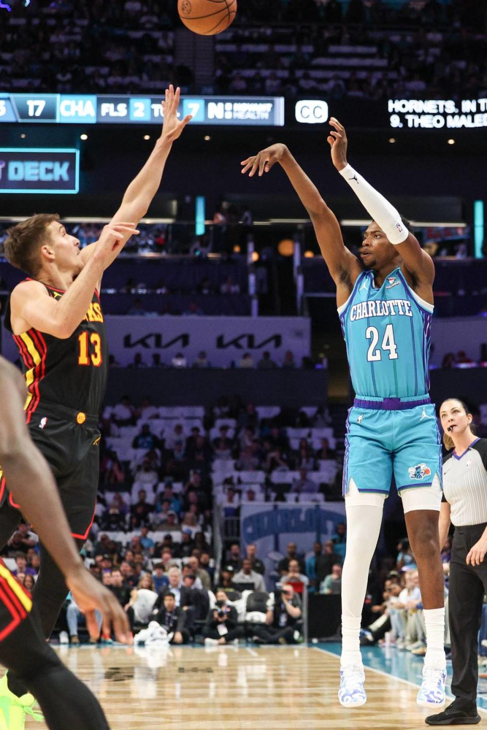 Hornets rookie Brandon Miller, right, shoots from the three-point line during the game against the Hawks at Spectrum Center on Wednesday, October 25, 2023.