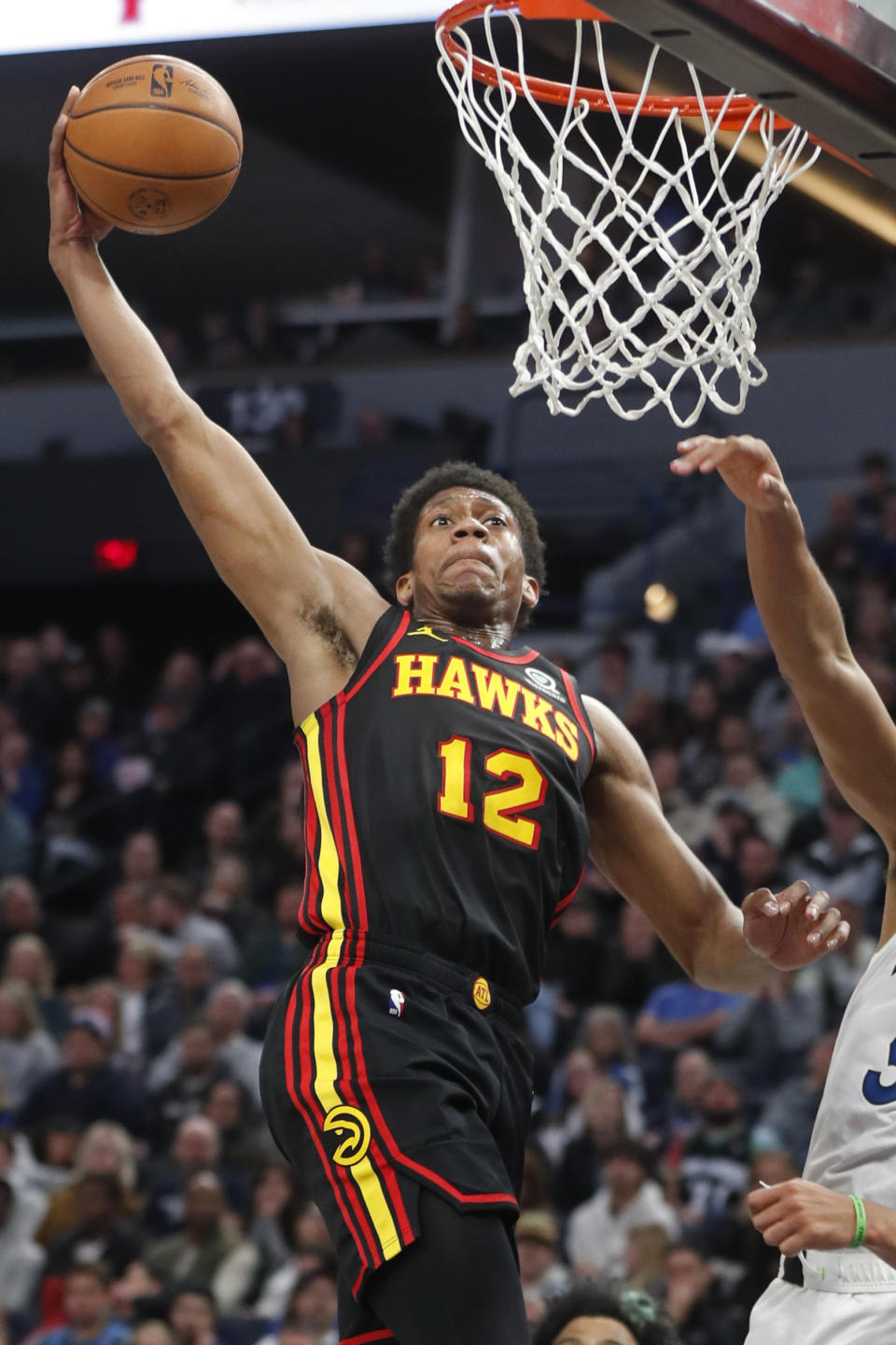 Atlanta Hawks forward De'Andre Hunter (12) dunks against the Minnesota Timberwolves in the third quarter of an NBA basketball game Wednesday, March 22, 2023, in Minneapolis. The Timberwolves won 125-124. (AP Photo/Bruce Kluckhohn)