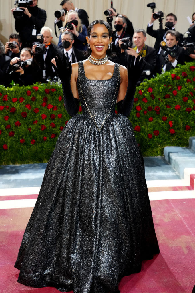 Laura Harrier smiling and standing on the red carpet