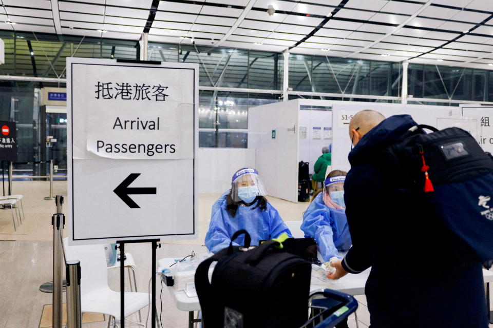 A traveller waits for PCR test to prevent the spread of the coronavirus disease (COVID-19), as he arrives at the Hong Kong International Airport, in Hong Kong, China February 21, 2022. REUTERS/Tyrone Siu