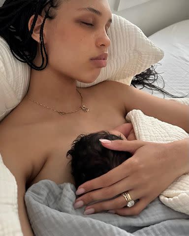 <p>Nara Smith Instagram</p> Nara Smith cuddling with her newborn daughter, Whimsy Lou Smith, in April 2024