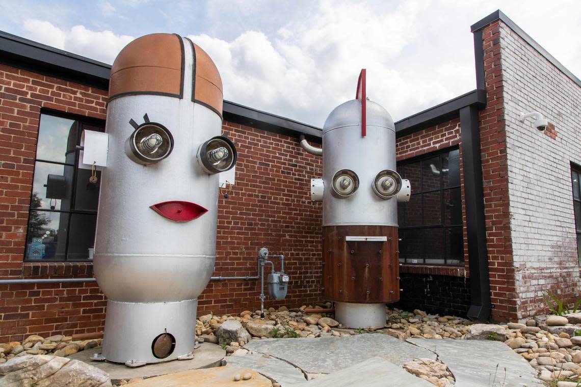 Giant robot heads on North Main Street in Columbia, South Carolina on Saturday, July 9, 2022. The sculptures are featured in a scavenger hunt for kids.