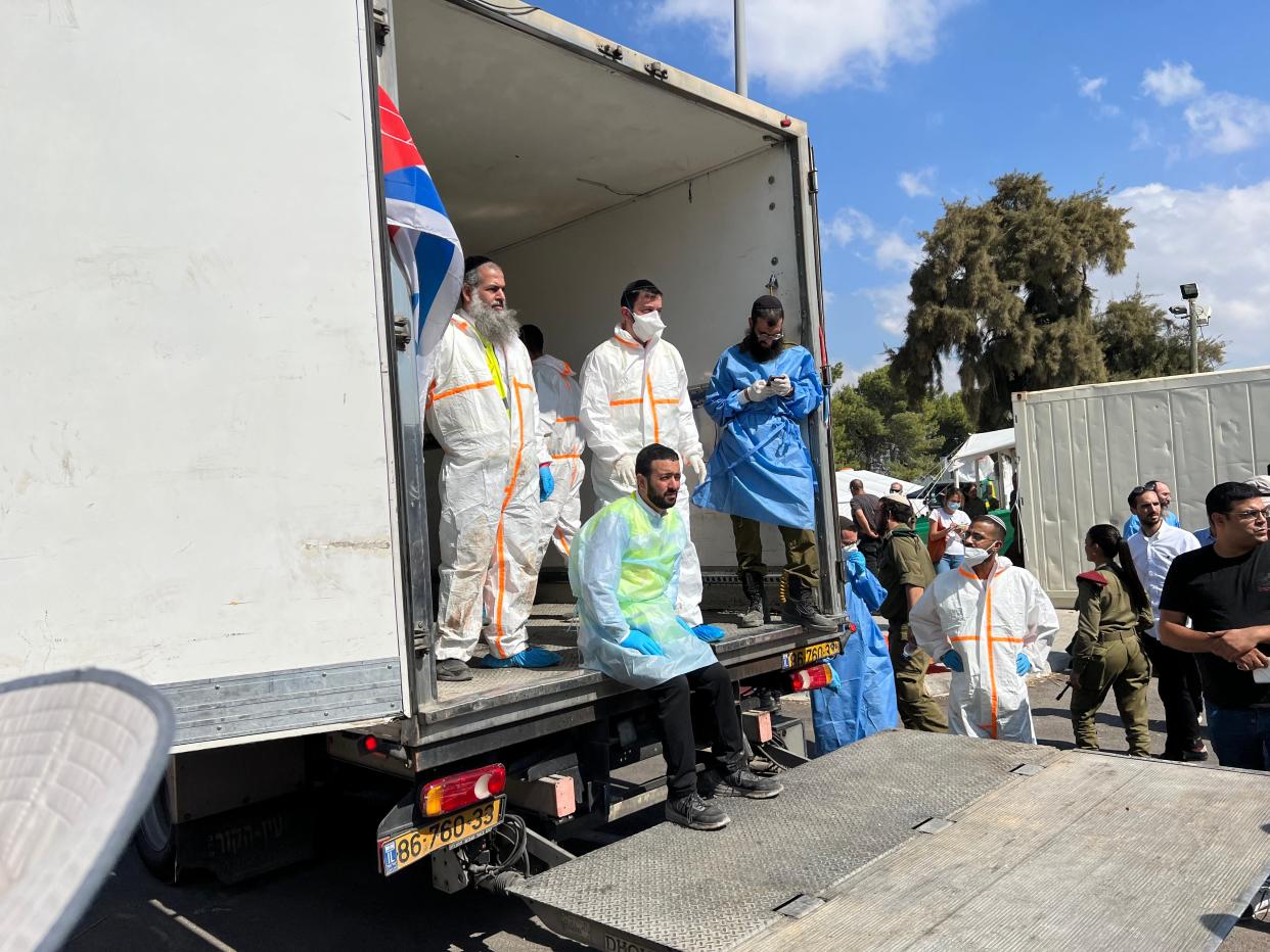 Israel's ZAKA volunteers, an organization whose members are almost all ultra-Orthodox Jews, stand in a truck used to transport victims of Hamas' attack on Israel.