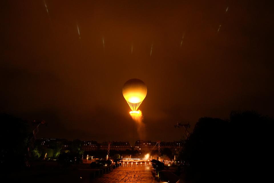 The Olympic flame rises above the city (Copyright 2024 The Associated Press. All rights reserved)