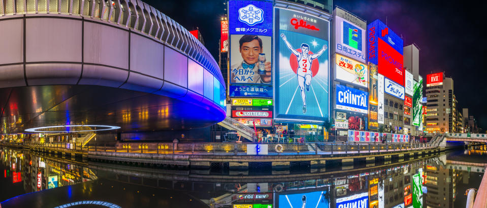 Panoramic view along the Dotonbori Canal beneath the iconic neon billboards of this busy and popular shopping and restaurant district in the heart of Osaka, Japan’s vibrant second city.