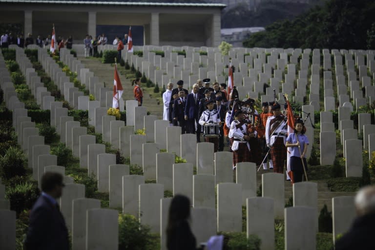 A pipes and drums band, comprised of members of the Hong Kong Police Force and Royal Canadian Mounted Police, leads a procession during the Canadian Commemorative Ceremony honouring those who died during the Battle of Hong Kong and World War II