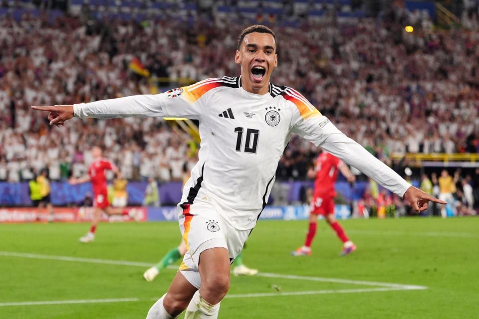 Jamal Musiala celebrates scoring Germany’s second goal against Denmark, his third of the tournament (PA)