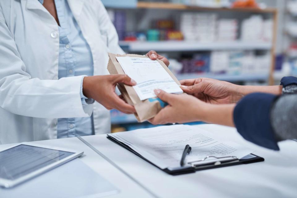 <p>Getty</p> pharmacist assisting a customer -- stock image