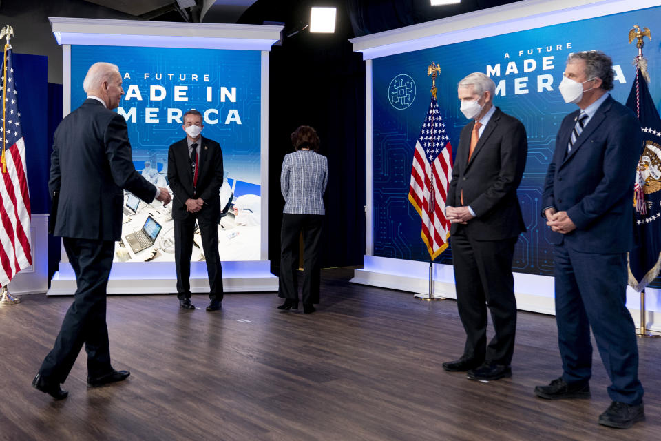 President Joe Biden, accompanied by from left, Intel CEO Patrick Gelsinger, Commerce Secretary Gina Raimondo, Sen. Rob Portman, R-Ohio, and Sen. Sherrod Brown, D-Ohio, leaves after speaking about Intel's announcement to invest in an Ohio chip making facility, at the South Court Auditorium in the Eisenhower Executive Office Building on the White House Campus in Washington, Friday, Jan. 21, 2022. (AP Photo/Andrew Harnik)