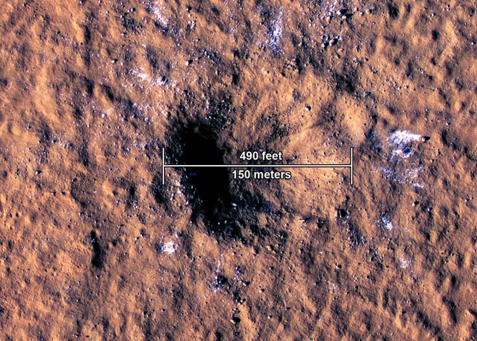 The impact crater, formed Dec. 24, 2021, by a meteorite strike in the Amazonis Planitia region of Mars, is about 490 feet across, as seen in this annotated image taken by NASA’s Mars Reconnaissance Orbiter.