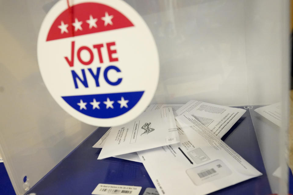 FILE - Absentee ballots sit in a ballot box during early voting in the primary election, Monday, June 14, 2021, at the Church of St. Anthony of Padua in the Soho neighborhood of New York. New York City, long a beacon for immigrants, is on the cusp of becoming the largest place in the U.S. to give noncitizens the right to vote. Legally documented, voting-age noncitizens, who comprise nearly one in 10 of the city's 8.8 million inhabitants, would be allowed to cast votes in elections to pick the mayor, City Council members and other municipal officeholders under a bill nearing approval.(AP Photo/Mary Altaffer, File)