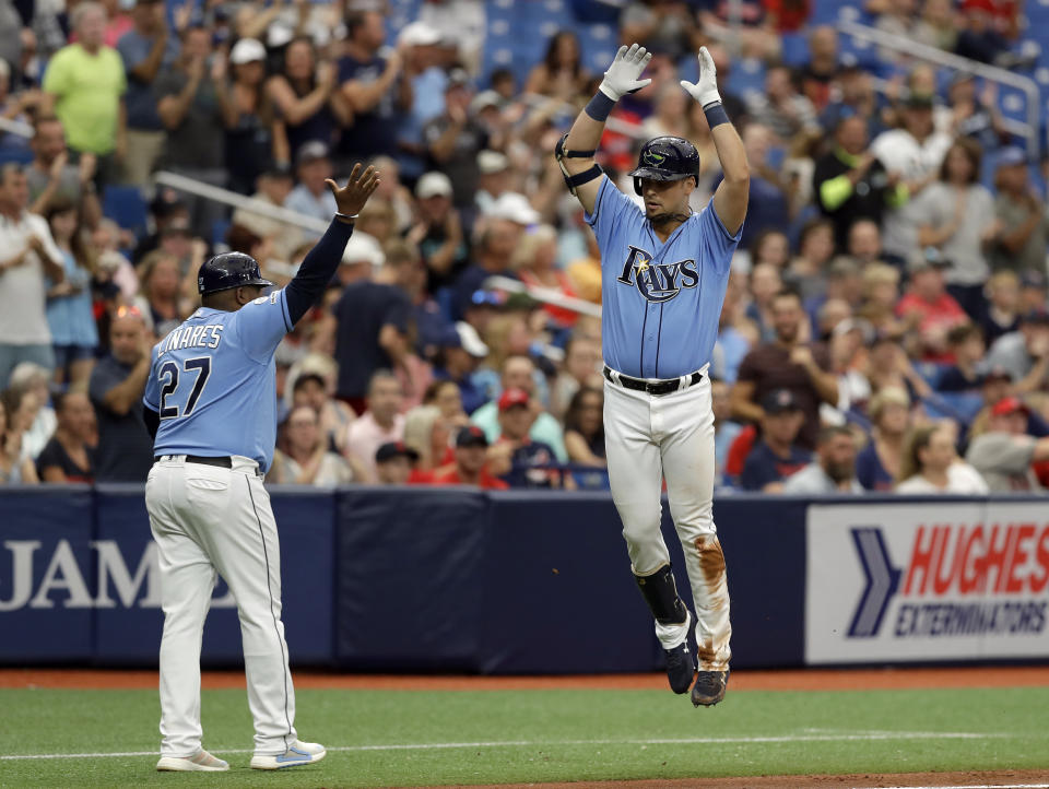 Tampa Bay Rays' Nate Lowe, right, celebrates with third base coach Rodney Linares (27) after hitting a two-run home run off Cleveland Indians starting pitcher Adam Plutko during the fourth inning of a baseball game Sunday, Sept. 1, 2019, in St. Petersburg, Fla. (AP Photo/Chris O'Meara)