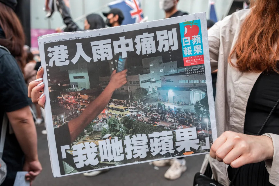 LONDON, UNITED KINGDOM - 2021/07/01: A protestor holds a copy of Apple Daily during the demonstration.
1st July this year marks the 24th year since Hong Kong's handover from the British government to the People's Republic of China. In light of the revolution in Hong Kong in recent years against the government's suppression of freedoms in the city, The Hong Kong diaspora in London gathered at China Town, expressing solidarity with freedom fighters who gave their lives in the killings in Hong Kong, and to raise awareness of the evil deeds of the Chinese Communist Party. The group later marched from China Town to the Hong Kong Economic Trade Office to lay down flowers and set off a few bombs. (Photo by Belinda Jiao/SOPA Images/LightRocket via Getty Images)