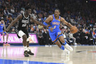 Oklahoma City Thunder forward Jalen Williams (8) drives past San Antonio Spurs guard Sidy Cissoko during the first half of an NBA basketball game Wednesday, April 10, 2024, in Oklahoma City. (AP Photo/Kyle Phillips)