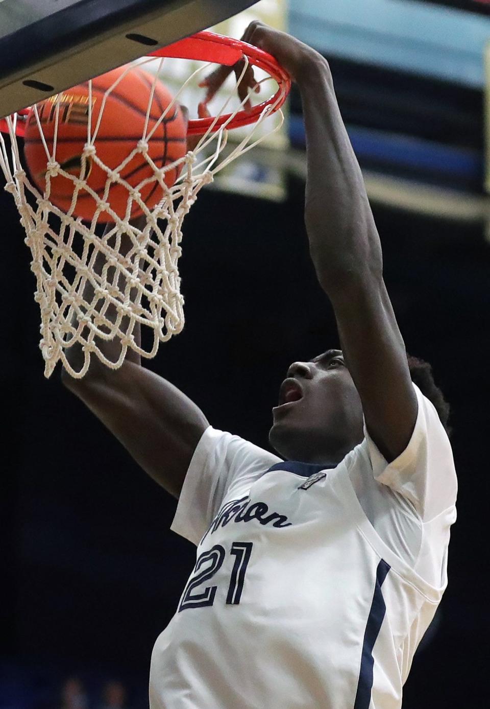 University of Akron center Aziz Bandaogo (21) dunks the ball during the first half of a 66-55 win over Miami University on Friday night at Rhodes Arena. [Jeff Lange/Beacon Journal]