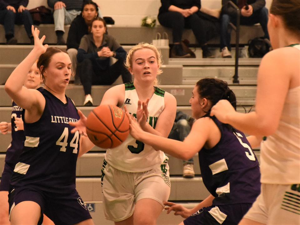 Herkimer Magician Aubrey Lewis passes between Little Falls Mounties Molly Podlas and Andy-Lynn Podlas (from left) Monday.