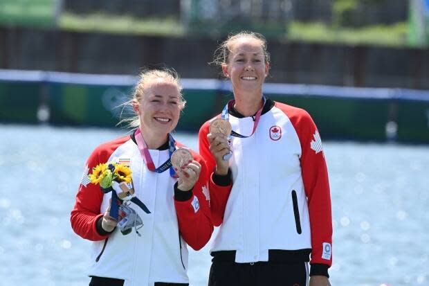 Canada's Caileigh Filmer and Hillary Janssens pose on the podium following their bronze-medal win in the women's pair final during the Tokyo 2020 Olympic Games at the Sea Forest Waterway in Tokyo on July 29. (Luis Acosta/AFP via Getty Images - image credit)