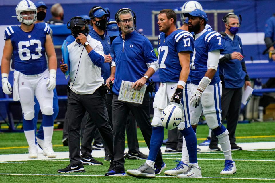 Indianapolis Colts head coach Frank Reich talks with quarterback Philip Rivers (17) in the first half of an NFL football game against the New York Jets in Indianapolis, Sunday, Sept. 27, 2020.