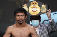 FILE - In this Aug. 20, 2021, file photo, Manny Pacquiao, of the Philippines, poses for photographers during a weigh-in in Las Vegas. Philippine boxing icon and senator Pacquiao says he will run for president in the 2022 elections. He accepted the nomination of his PDP-Laban party at its national convention on Sunday, Sept. 19, pledging to honestly serve the Filipino people who he said have been waiting for change in government. (AP Photo/John Locher, File)