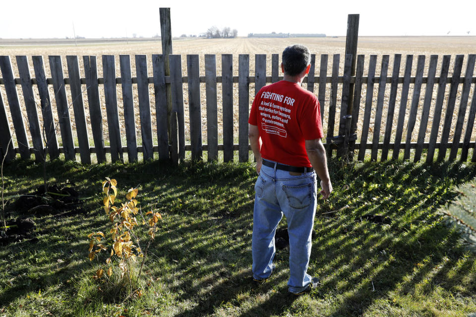 In this Oct. 29, 2018, photo, Jeff Schwartzkopf, of Rudd, Iowa, looks at the concentrated animal feeding operation, or CAFO, built near his home in Rudd, Iowa. Jeff and Gail Schwartzkopf say their lives changed drastically after a hog operation was built a quarter-mile from their home in northern Iowa. (AP Photo/Charlie Neibergall)