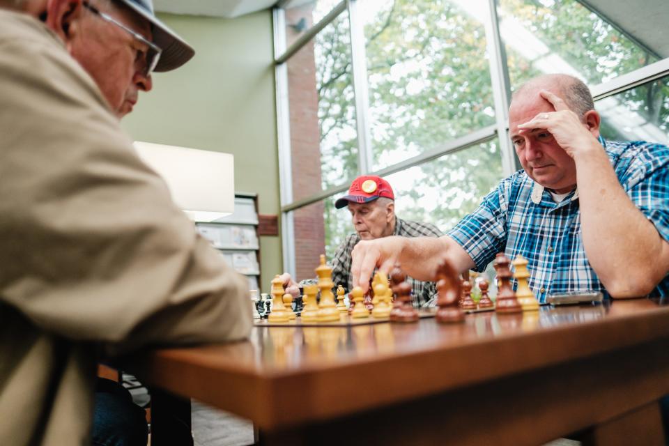 Bill Houghlan, right, of Dover, makes a chess move, Wednesday, Sept. 27, at the Dover Public Library. The chess club is informal and all are welcome.