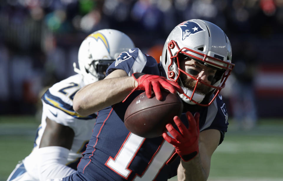 New England Patriots wide receiver Julian Edelman (11) catches a pass in front of Los Angeles Chargers defensive back Desmond King during the first half of an NFL divisional playoff football game, Sunday, Jan. 13, 2019, in Foxborough, Mass. (AP Photo/Charles Krupa)