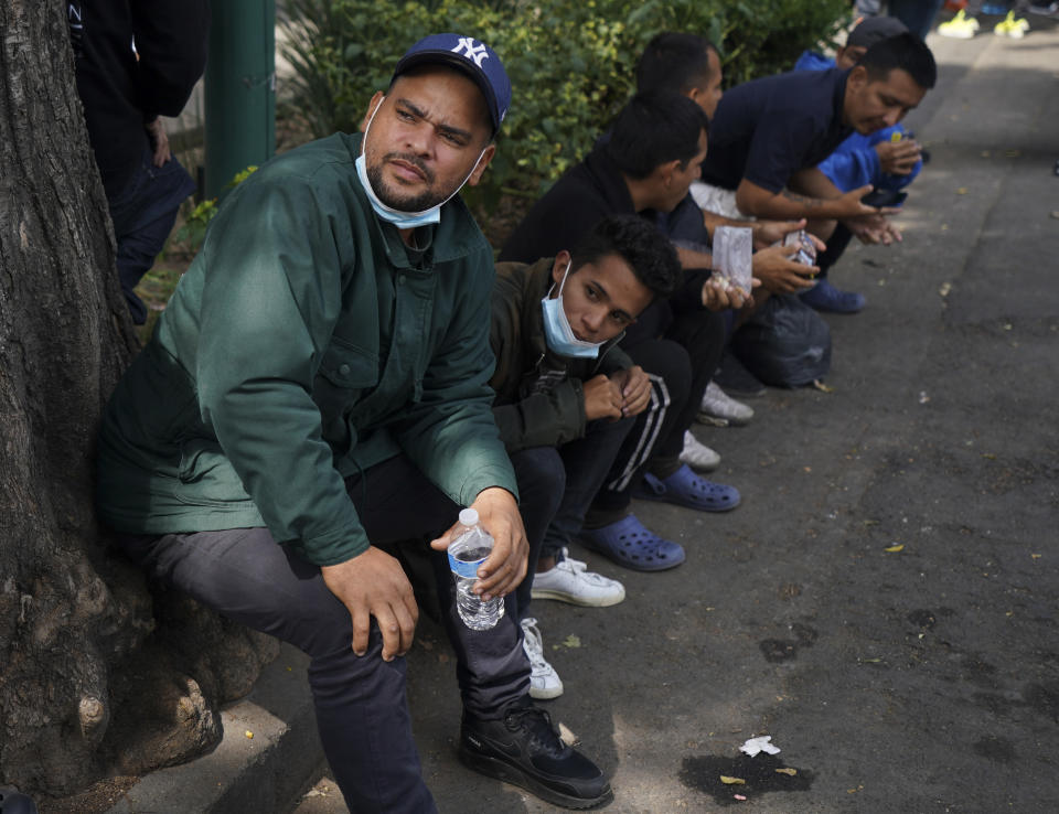 Venezuelan migrants wait for assistance outside of the Mexican Commission for Refugee Aid in Mexico City, Thursday, Oct. 20, 2022. This group of migrants interrupted their trek in Mexico City after the U.S. announced that Venezuelans who walk or swim across the border will be immediately returned to Mexico without the right to seek asylum. (AP Photo/Fernando Llano)