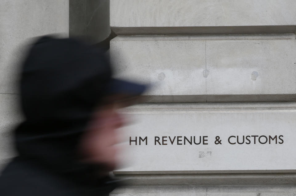 A pedestrian walks past the headquarters of Her Majesty's Revenue and Customs (HMRC) in central London February 13, 2015. British lawmakers plan to call up the bosses of HSBC and the tax authority, HMRC, to quiz them over allegations some clients of HSBC's Swiss private bank evaded tax.     REUTERS/Stefan Wermuth (BRITAIN - Tags: BUSINESS POLITICS CRIME LAW)