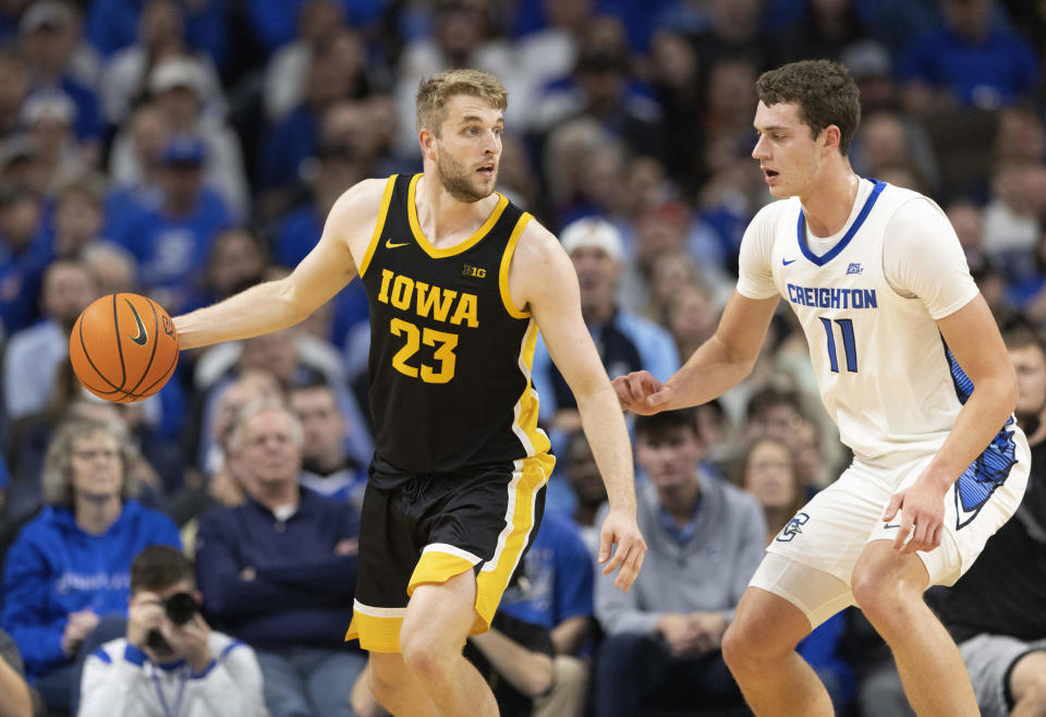 Iowa's Ben Krikke (23) is defended by Creighton's Ryan Kalkbrenner (11) during the first half of an NCAA college basketball game Tuesday, Nov. 14, 2023, in Omaha, Neb. (AP Photo/Rebecca S. Gratz)