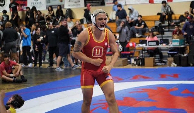 Oxnard's Joshua Godinez celebrates winning a match during the Channel League wrestling championships on Saturday at San Marcos High. Godinez won the 192-pound title and was named the Upper Weight MVP.