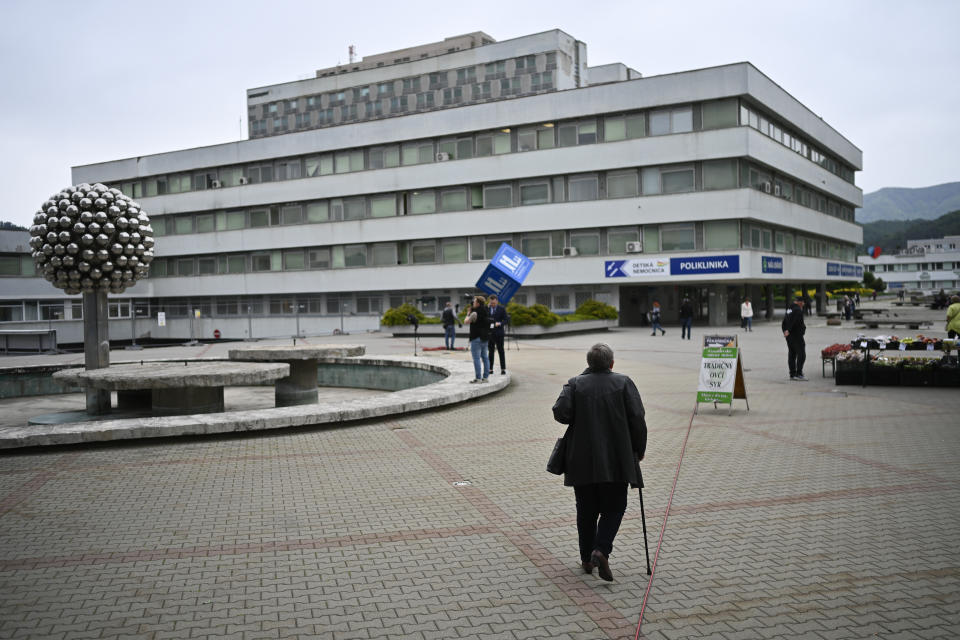 People walk outside the F. D. Roosevelt University Hospital, where Slovak Prime Minister Robert Fico, who was shot and injured, is treated, in Banska Bystrica, central Slovakia, Friday, May 17, 2024. Fico, 59, was shot multiple times on Wednesday as he was greeting supporters after a government meeting in the former coal mining town of Handlova. Officials at first reported that doctors were fighting for his life but after a five-hour operation described his situation as serious but stable. (AP Photo/Denes Erdos)
