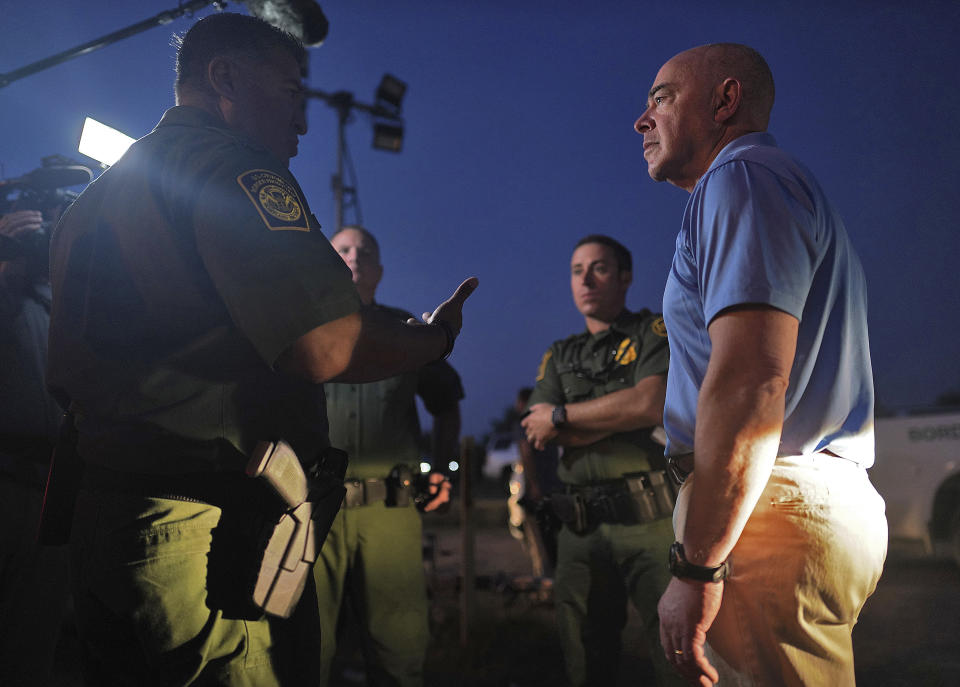 Homeland Security Secretary Alejandro Mayorkas listens to Raul Ortiz, Chief, U.S. Border Patrol, as he tours the section of the border wall with Mexico, Tuesday, May 17, 2022, in La Joya, Texas. (Joel Martinez/The Monitor via AP, Pool)