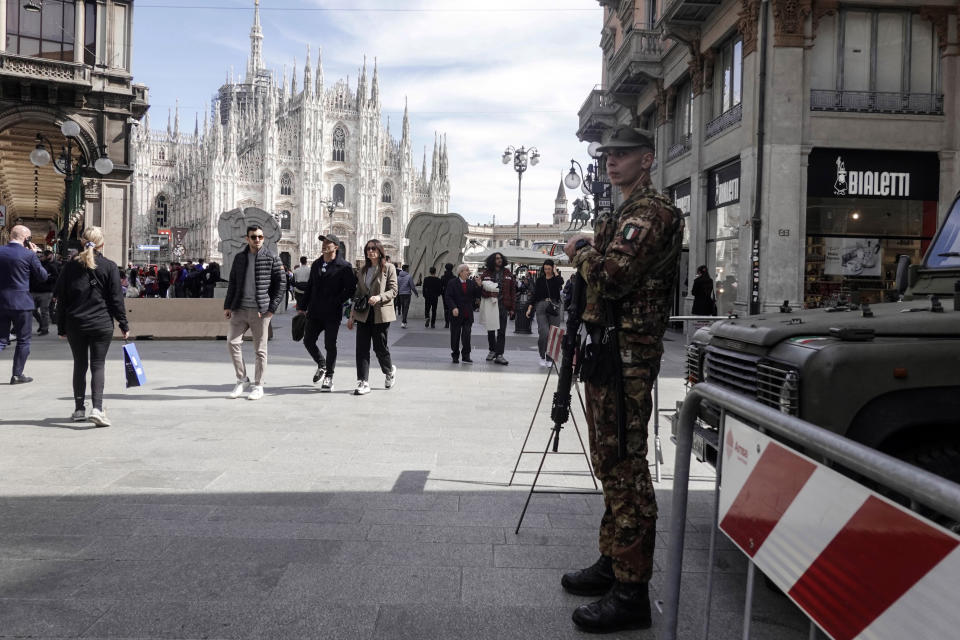 A soldier patrols in front of Milan gothic cathedral in Milan, Monday, March 25, 2024. Italy followed France Monday in stepping up its security stance following the attack on a suburban Moscow concert hall and the claim of responsibility by an affiliate of the Islamic State group. (AP Photo/Luca Bruno)
