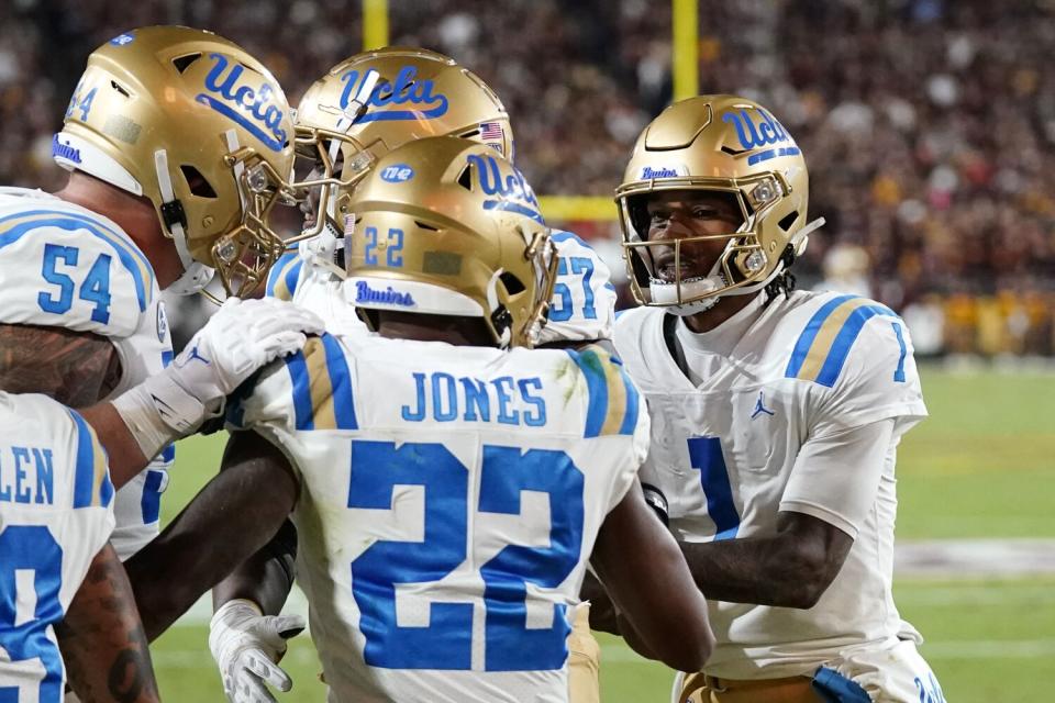 UCLA players celebrate a touchdown.