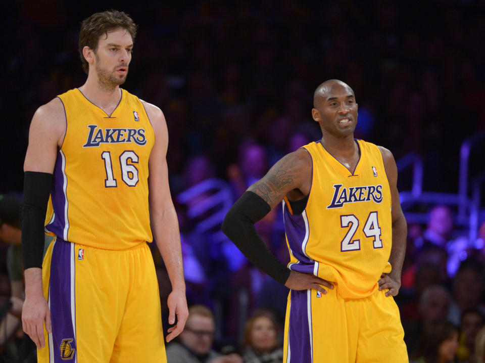 Dec 10, 2013; Los Angeles, CA, USA; Los Angeles Lakers forward Pau Gasol (16) and guard Kobe Bryant (24) react during the game against the Phoenix Suns at Staples Center. The Suns defeated the Lakers 114-108.