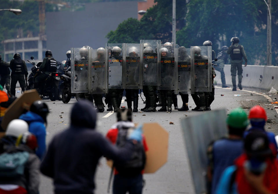 <p>Riot police take position while clashing with opposition supporters rallying against President Nicolas Maduro in Caracas, Venezuela, May 3, 2017. (Carlos Garcia Rawlins/Reuters) </p>