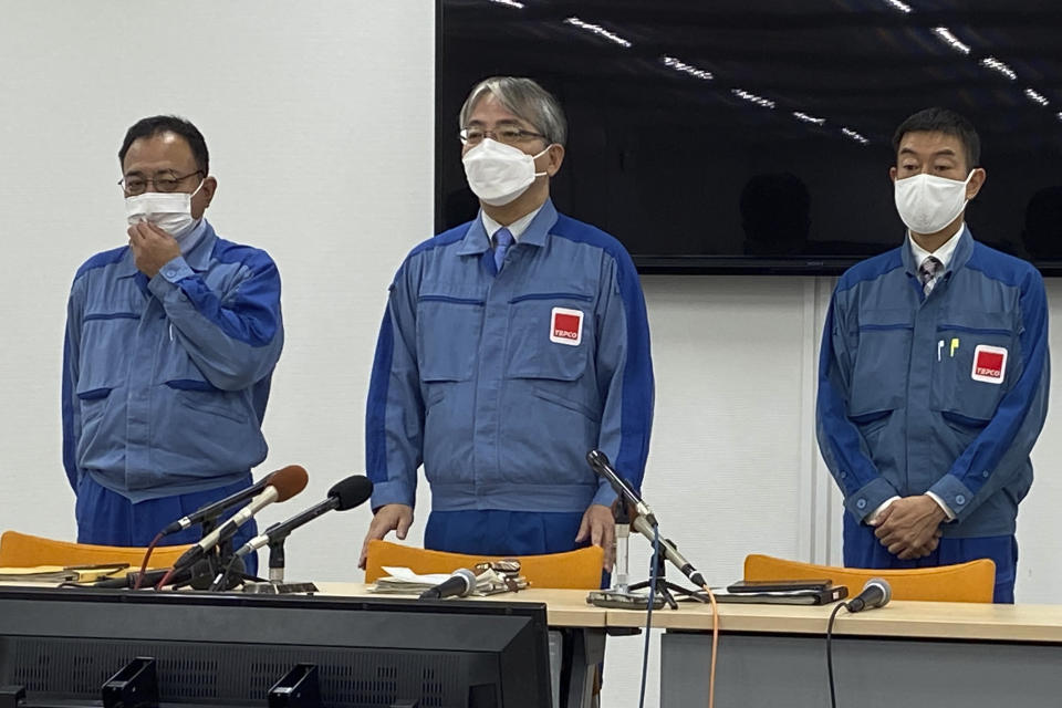 Tokyo Electric Power Company Holdings executive Junichi Matsumoto, center, who is in charge of the treated water release from the Fukushima Daiichi nuclear power plant, announces that the first batch of treated and diluted radioactive wastewater will be released into the Pacific Ocean later Thursday from the plant, in the Okuma town on the northeastern coast of Japan, Thursday, Aug. 24, 2023. The operator of the tsunami-wrecked Fukushima Daiichi nuclear power plant will begin releasing the first batch of treated and diluted radioactive wastewater into the Pacific Ocean later Thursday, the utility executives said. (AP Photo/Mari Yamaguchi)