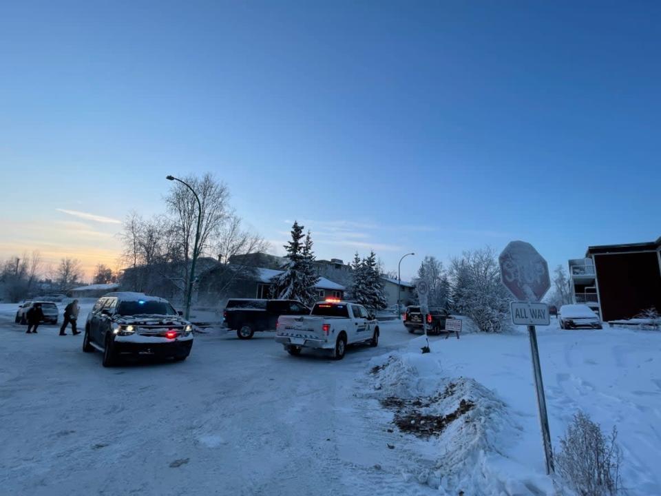 Police are seen on 51A Ave. where they blocked off the street during a standoff in downtown Yellowknife on Jan. 7. Two men are facing several charges from the incident.   (Kaicheng Xin/ CBC - image credit)