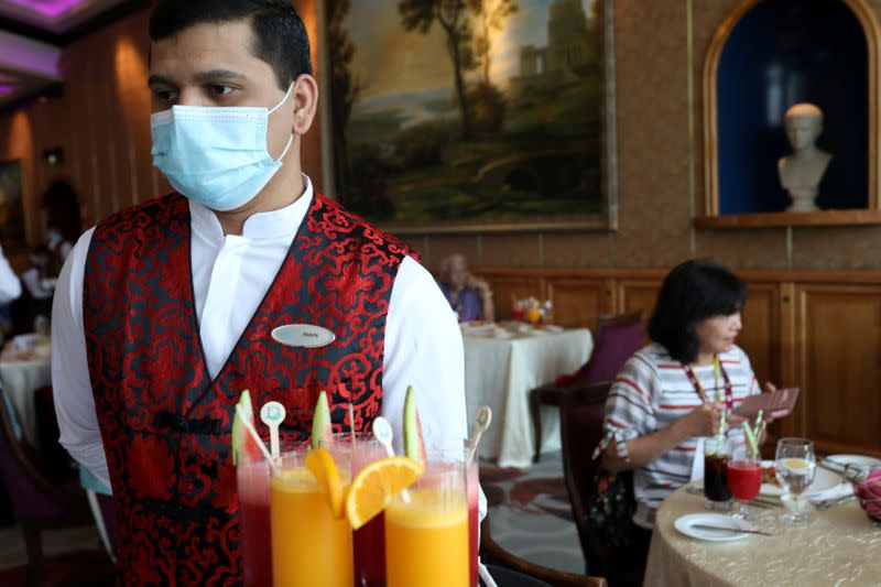 A member of the staff wears a face mask to prevent the spread of the coronavirus disease (COVID-19), at the canteen on Explorer Dream cruise ship in Keelung