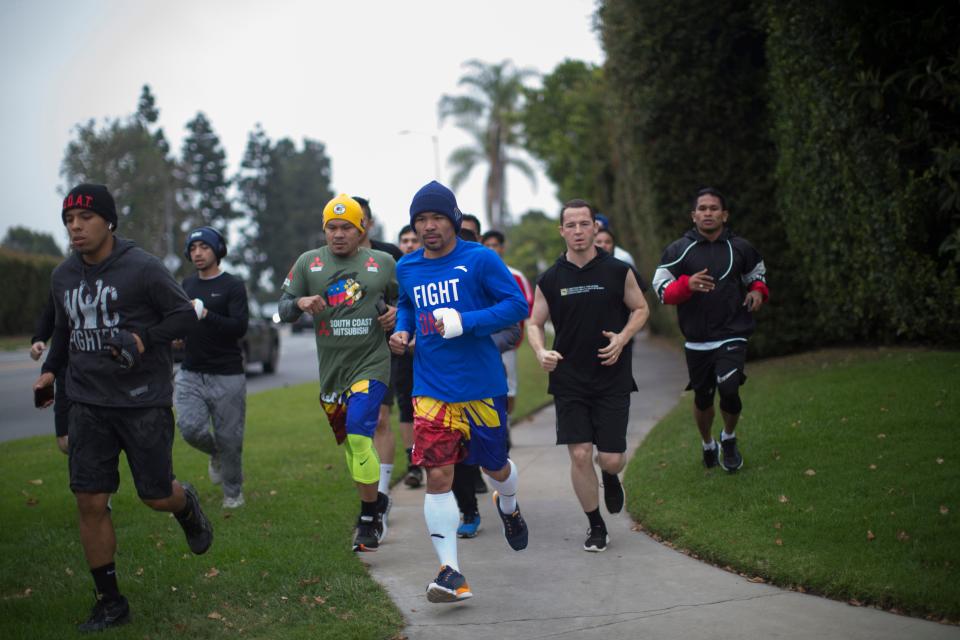 Filipino boxer Manny Pacquiao (C) jogs in the morning with fans and friends in Los Angeles on June 20, 2019. - Veteran trainer Freddie Roach says Manny Pacquiao has rediscovered his aggressive streak as the one-month countdown to his battle with welterweight champion Keith Thurman got under way on June 20. (Photo by Apu Gomes / AFP)        (Photo credit should read APU GOMES/AFP/Getty Images)