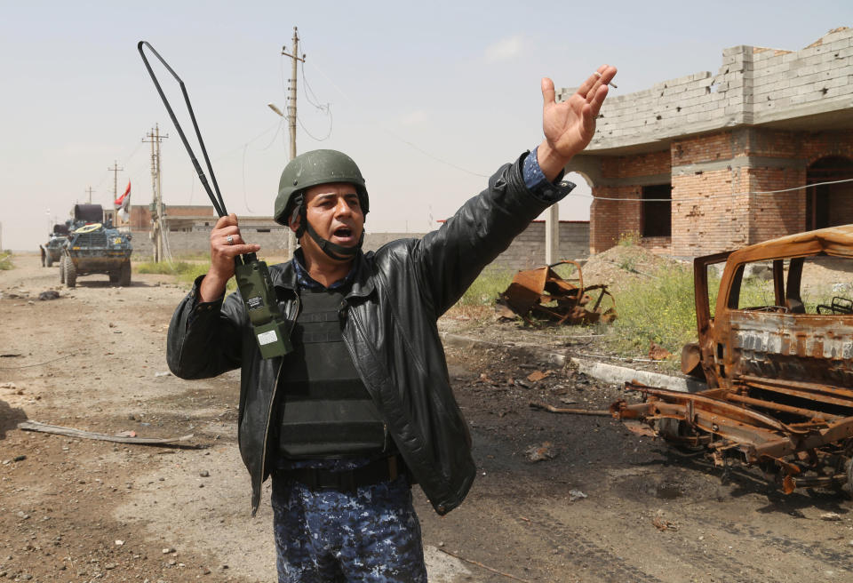 In this Monday, March 30, 2015 file photo, an Iraqi officer shouts orders as they attack Islamic State extremists  Tikrit, 80 miles  north of Baghdad, Iraq. (AP Photo/Khalid Mohammed, File)
