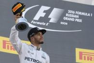 Formula One - Russian Grand Prix - Sochi, Russia - 1/5/16 - Mercedes F1 driver Lewis Hamilton of Britain holds his trophy after the Russian Grand Prix. REUTERS/Maxim Shemetov