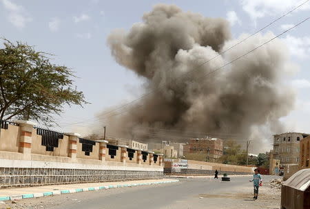 A girl runs for shelter during an air strike in Sanaa April 8, 2015. REUTERS/Khaled Abdullah