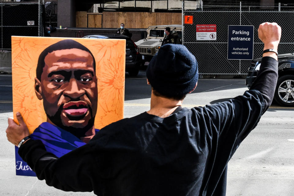 A demonstrator holds a portrait of George Floyd outside the Hennepin County Government Center on March 9, 2021 in Minneapolis, Minnesota.