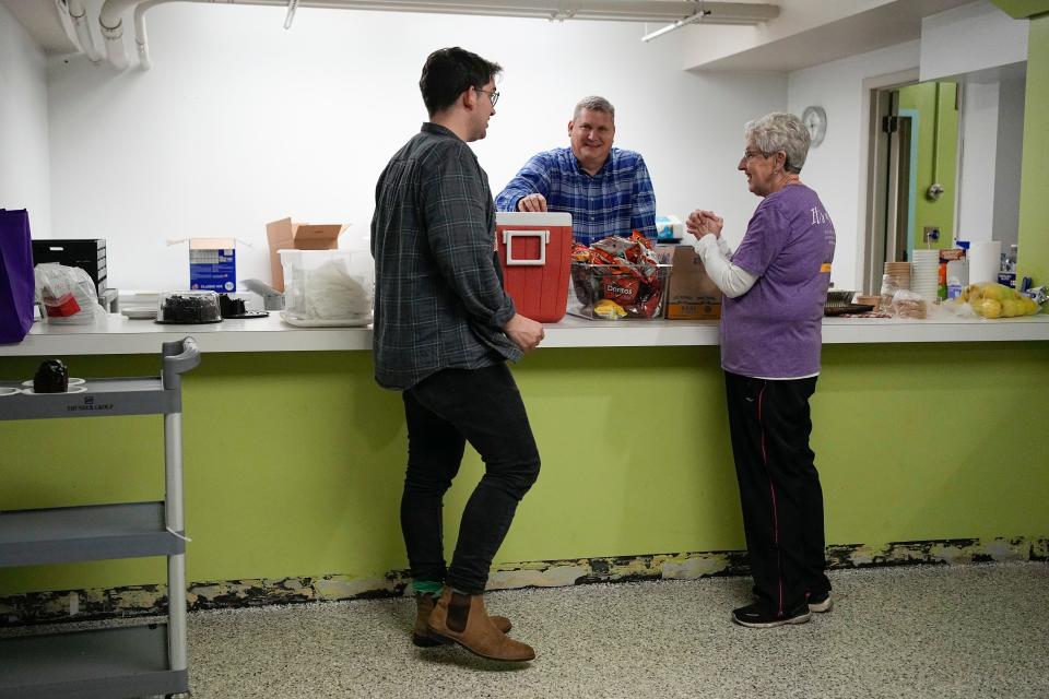 Volunteers David Butler, Bruce Moore and Cindy Kilbane (left to right) serve a free lunch for the hungry Wednesday at Trinity Episcopal Church through a partnership with St. John's United Church of Christ as part of the latter's "The Largest Table."
