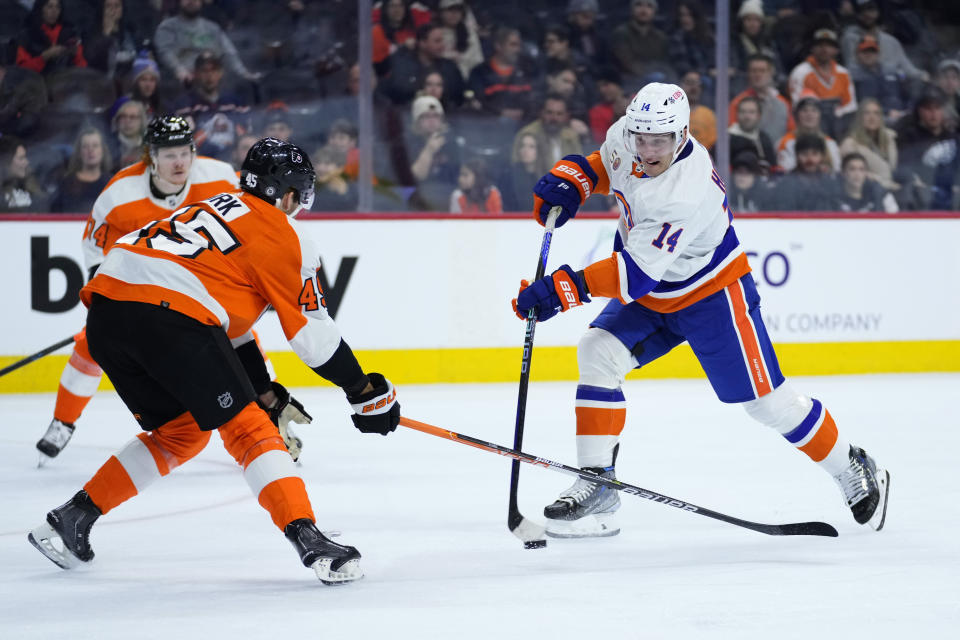 New York Islanders' Bo Horvat, right, shoots the puck against Philadelphia Flyers' Cam York during the first period of an NHL hockey game, Monday, Feb. 6, 2023, in Philadelphia. (AP Photo/Matt Slocum)