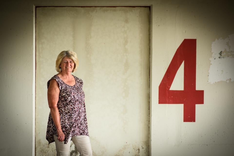 Judy Hawkins stands by one of the sealed off elevator shafts in the Hay Street parking deck. Hawkins, who has a bad knee, had to walk down four flights of stairs when she went to a recent Woodpeckers baseball game because the parking deck has no elevators.