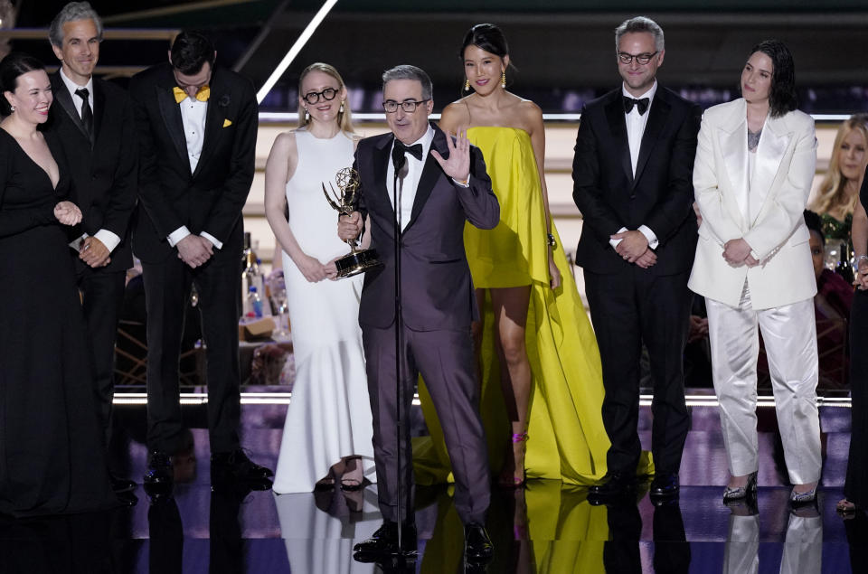 John Oliver, center, and the team from "Last Week Tonight with John Oliver" accepts the Emmy for outstanding variety talk series at the 74th Primetime Emmy Awards on Monday, Sept. 12, 2022, at the Microsoft Theater in Los Angeles. (AP Photo/Mark Terrill)