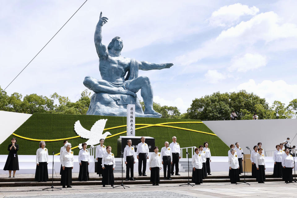 A choir group consist of victims of the historic bomb attack sing during the 77th anniversary of the Nagasaki atomic bombing in Nagasaki, southern Japan, Tuesday, Aug. 9, 2022. (Kyodo News via AP)